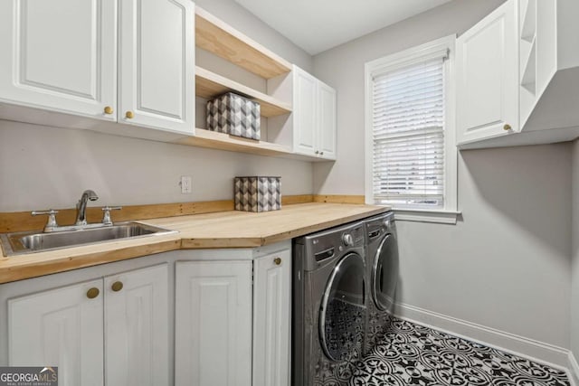 laundry room featuring cabinets, tile patterned floors, sink, and washer and dryer