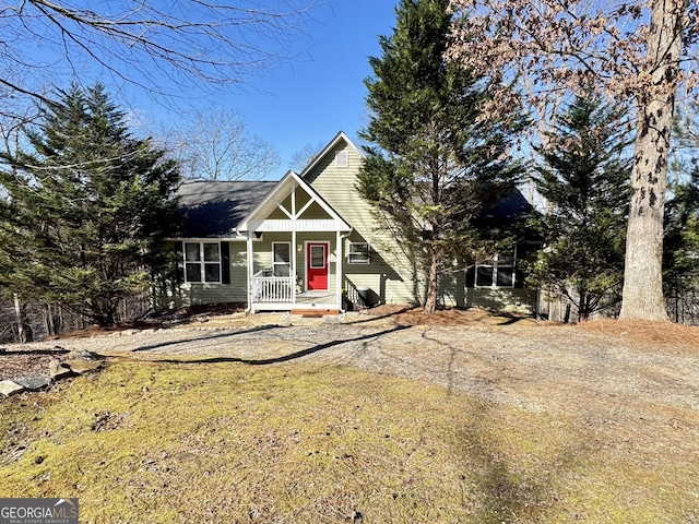 view of front of house with a porch and a front yard