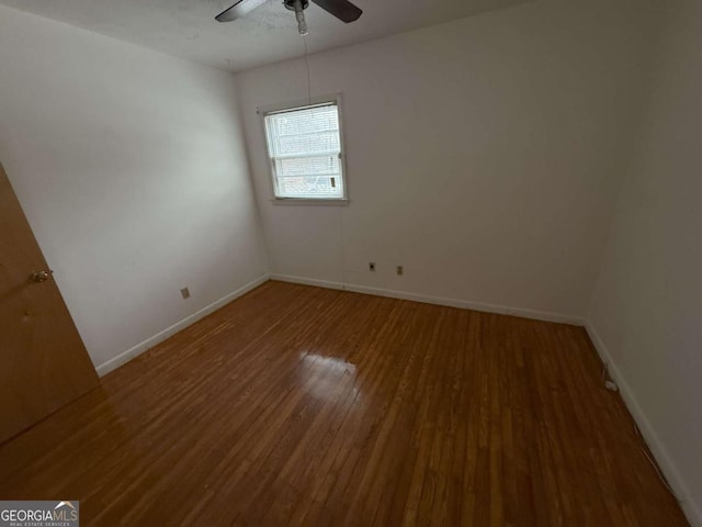 empty room featuring wood-type flooring and ceiling fan