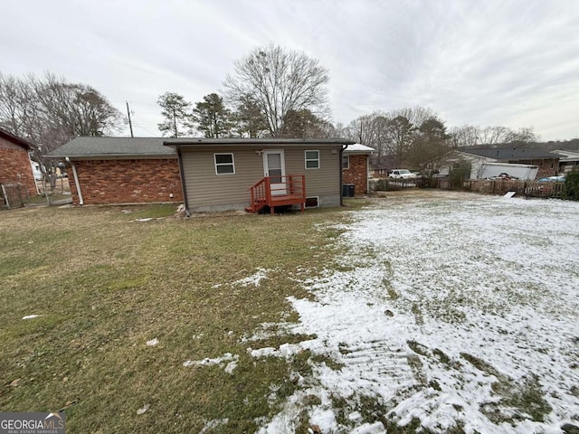 snow covered property with a yard