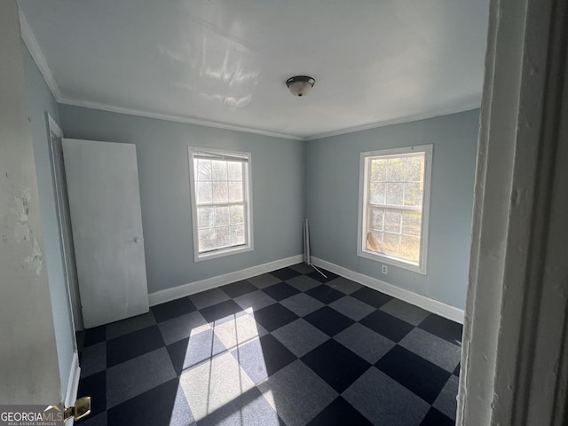 unfurnished room with ornamental molding