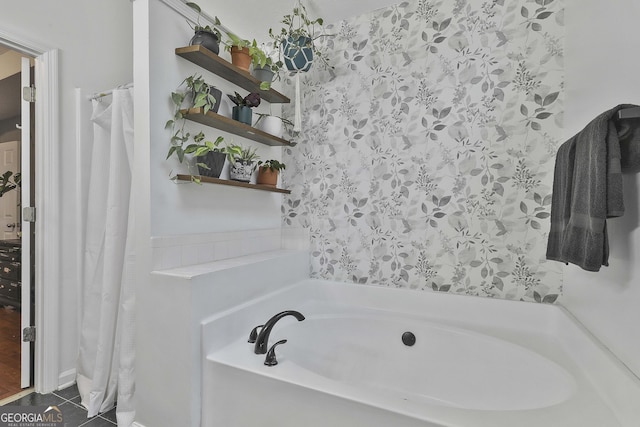 bathroom with tile patterned floors and a tub