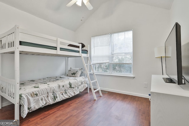 bedroom with ceiling fan, dark hardwood / wood-style flooring, and vaulted ceiling