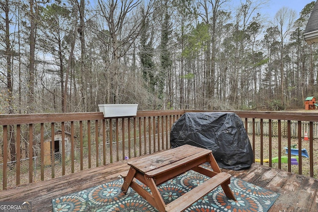 wooden terrace with a grill