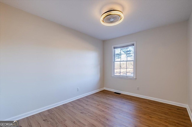 spare room featuring hardwood / wood-style flooring