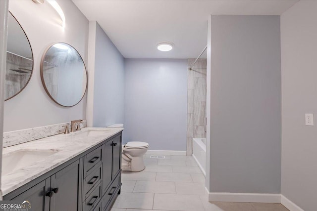 full bathroom featuring tiled shower / bath, vanity, toilet, and tile patterned flooring