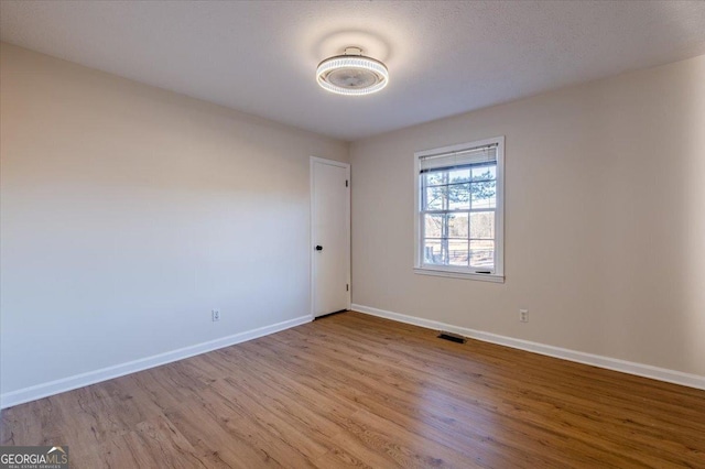 unfurnished room featuring light hardwood / wood-style flooring