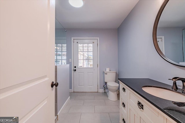 bathroom featuring vanity, toilet, and tile patterned flooring