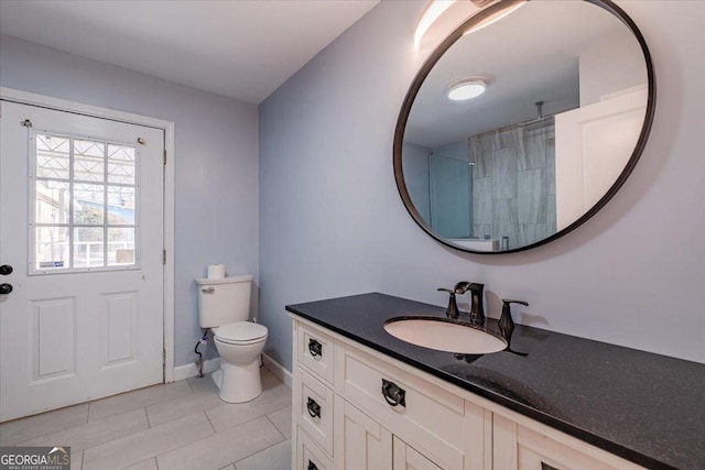 bathroom with vanity, toilet, tile patterned flooring, and a shower