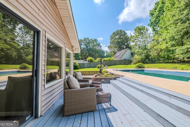 deck with a fenced in pool and a lawn