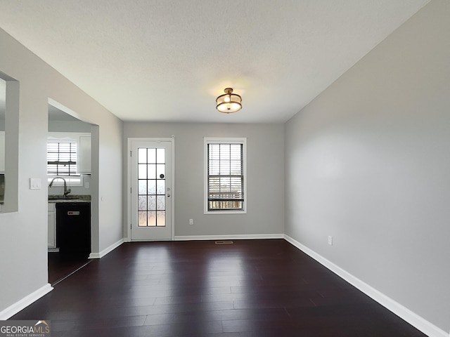 spare room with sink and dark hardwood / wood-style flooring