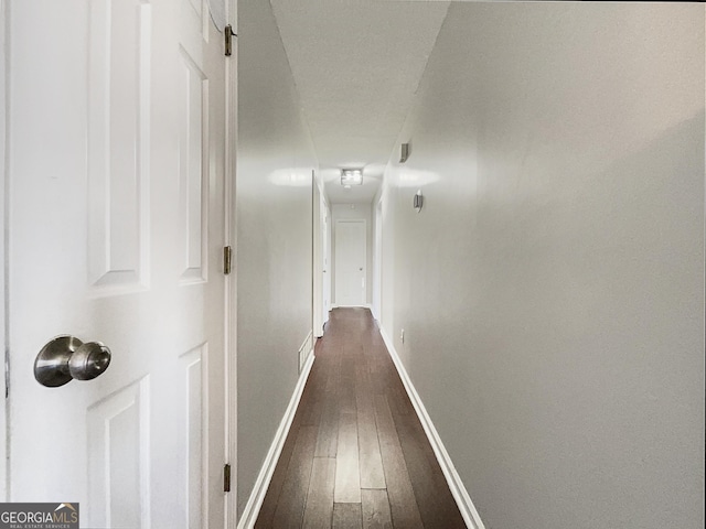 corridor with dark wood-type flooring