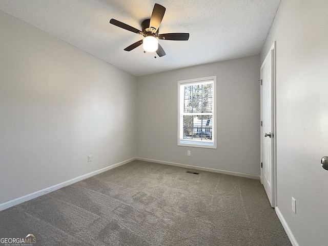 carpeted empty room featuring a textured ceiling and ceiling fan