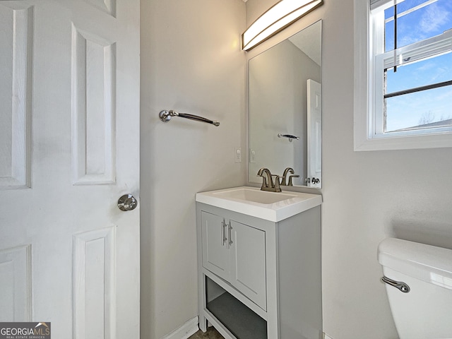 bathroom featuring vanity and toilet