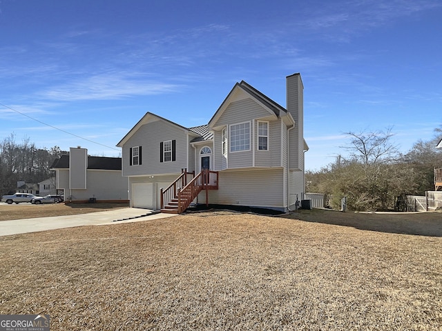 bi-level home featuring a garage and central AC