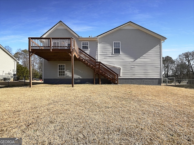 rear view of house with a yard and a deck