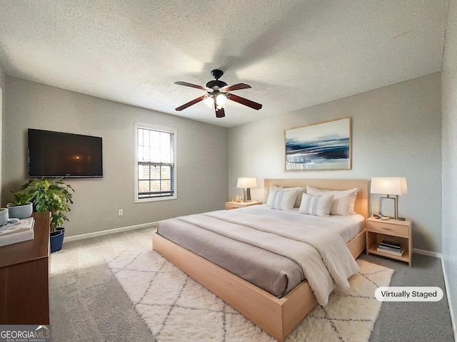 bedroom with light colored carpet, a textured ceiling, and ceiling fan