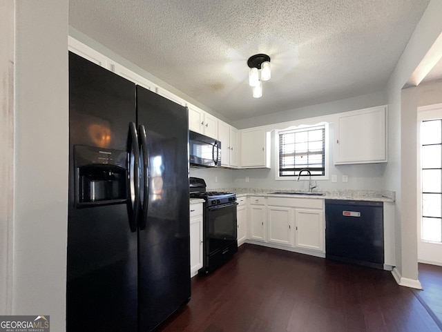 kitchen with sink, white cabinets, dark hardwood / wood-style floors, and black appliances