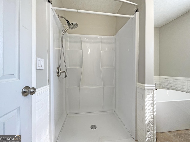 bathroom with separate shower and tub