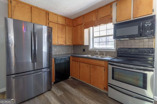 kitchen featuring sink, dark wood-type flooring, backsplash, black appliances, and a textured ceiling