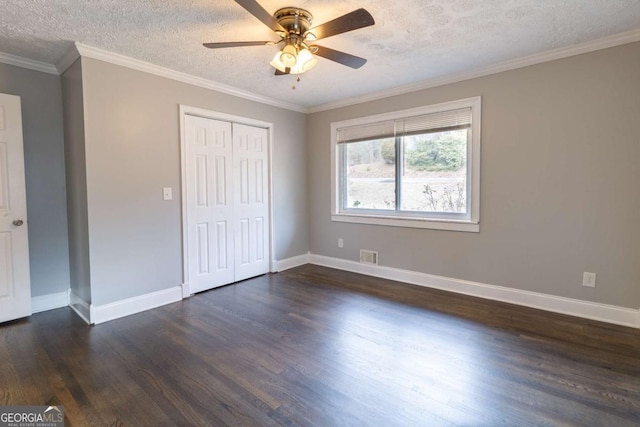 unfurnished bedroom with crown molding, a textured ceiling, ceiling fan, and a closet