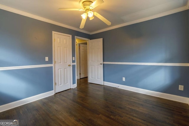 empty room featuring ceiling fan, ornamental molding, and dark hardwood / wood-style flooring