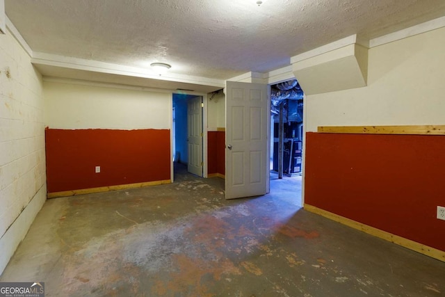 basement featuring a textured ceiling