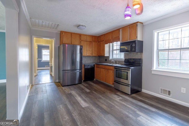 kitchen featuring sink, crown molding, backsplash, black appliances, and a healthy amount of sunlight