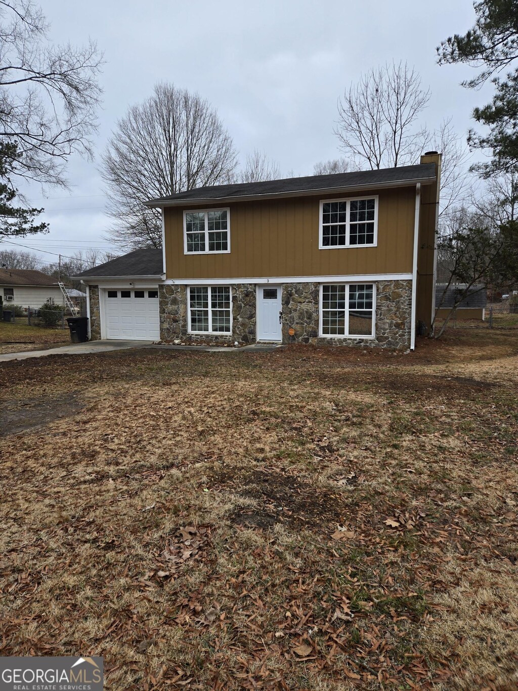 3 Round Tree Ter NW, Rome, GA 30165 - view of front facade featuring an attached garage, stone siding, and a chimney