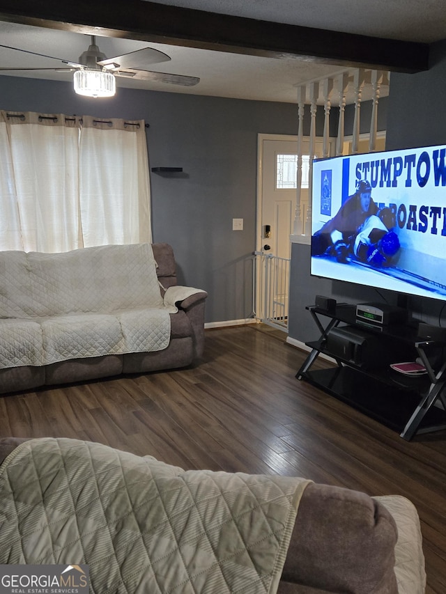 living room featuring beamed ceiling, ceiling fan, and wood-type flooring