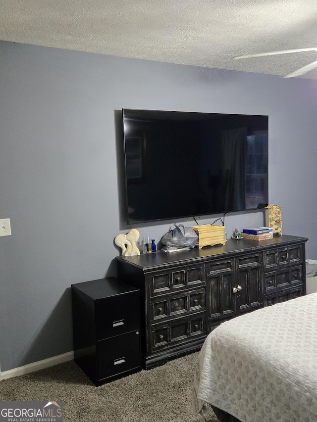 carpeted bedroom featuring a textured ceiling