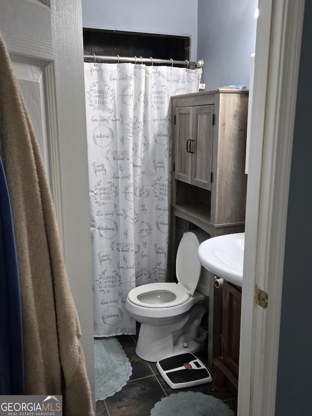 bathroom featuring tile patterned flooring, vanity, and toilet