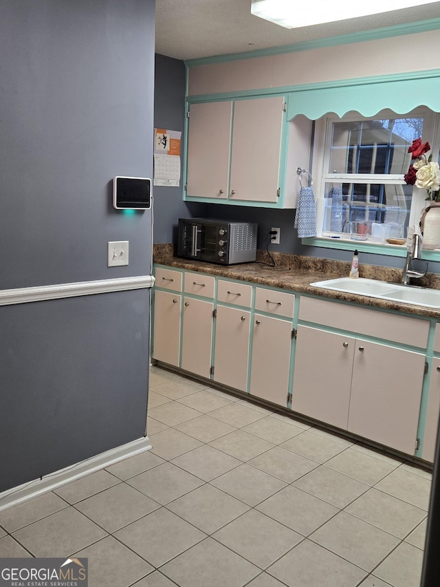 kitchen with light tile patterned flooring and sink