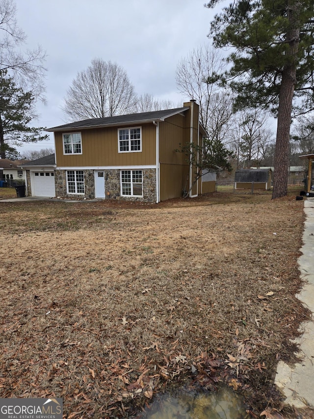 view of front of property with a garage and a front lawn