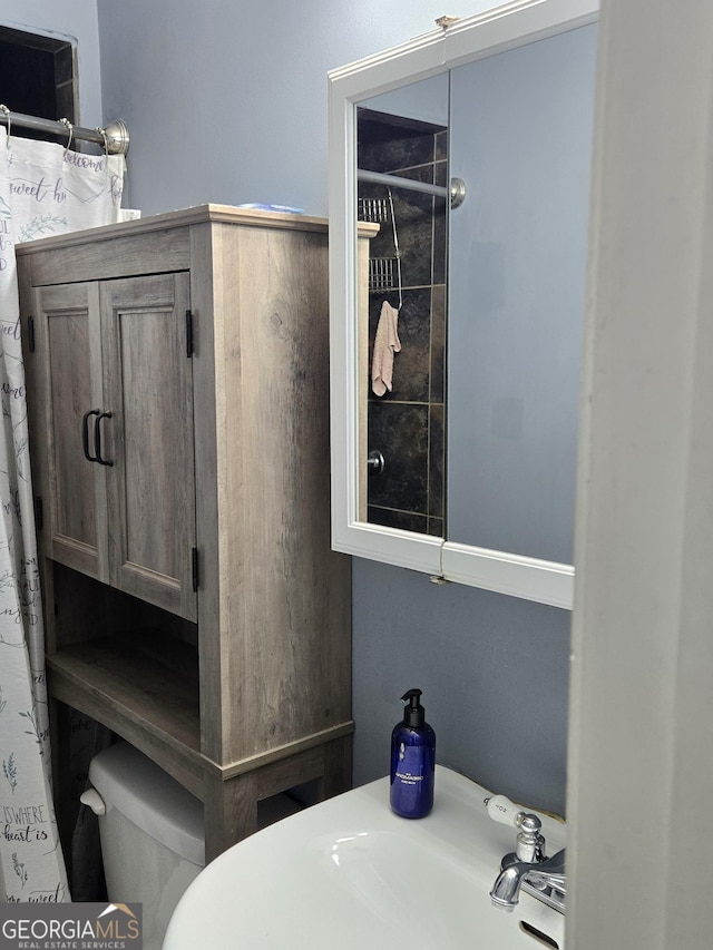 bathroom with a shower with curtain and toilet