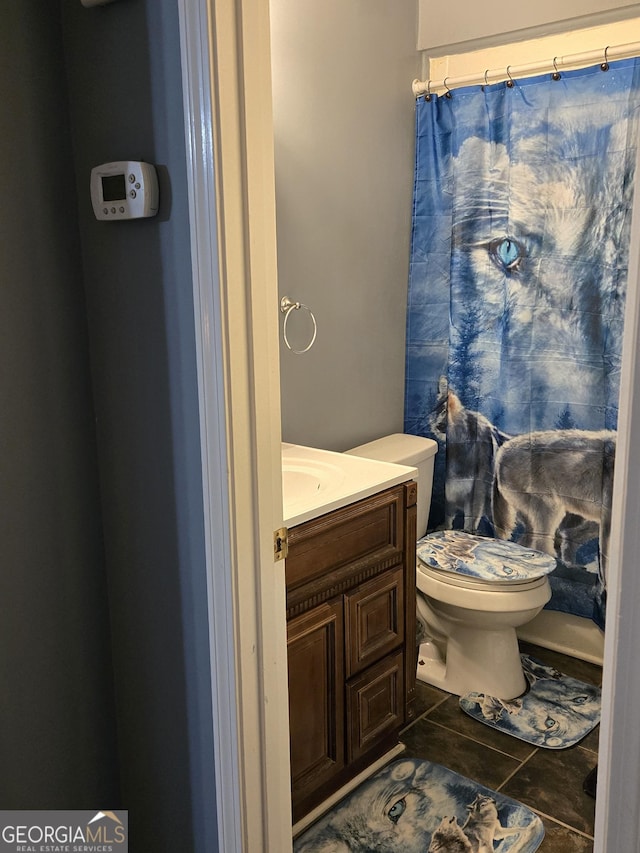 bathroom featuring vanity, tile patterned floors, and toilet