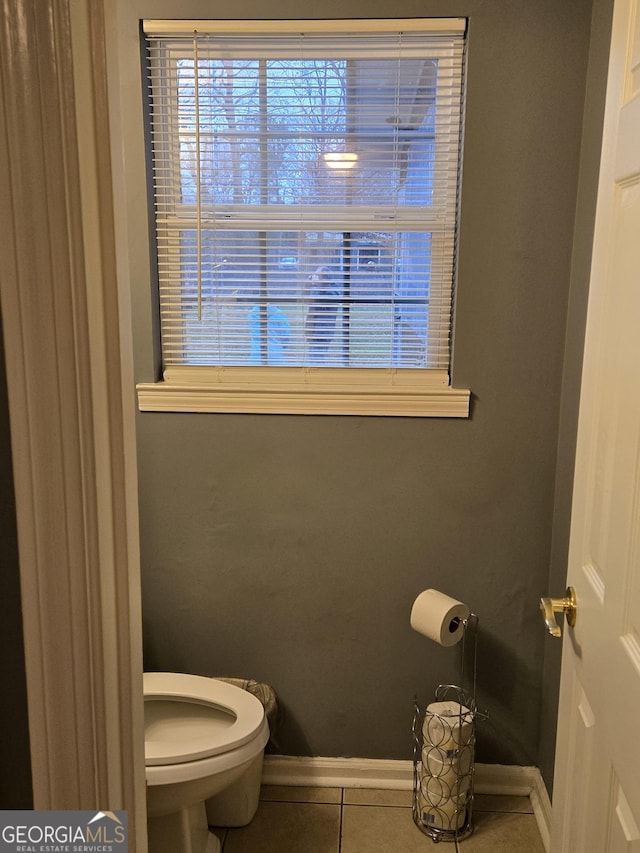 bathroom with toilet and tile patterned flooring