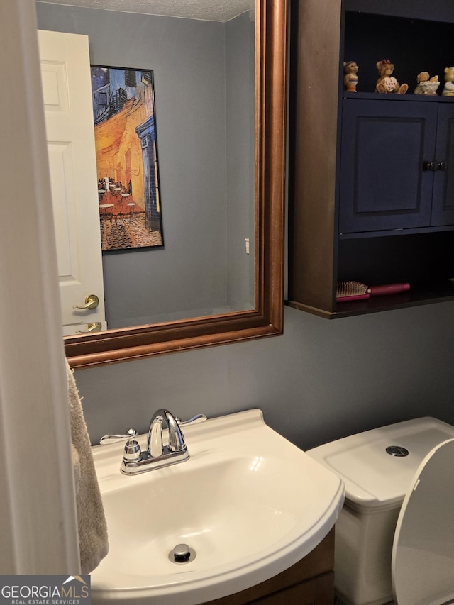 bathroom featuring sink and a textured ceiling