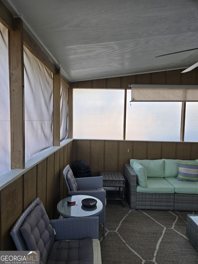 sunroom / solarium featuring lofted ceiling and ceiling fan