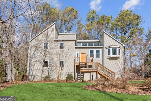 back of house with a lawn and a deck