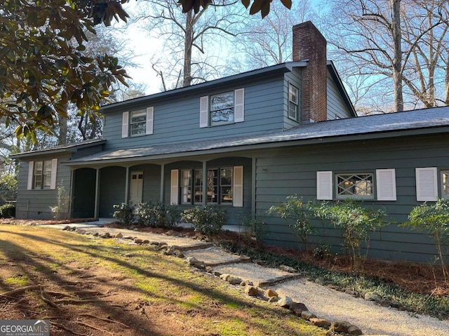 view of front facade featuring a front lawn and covered porch