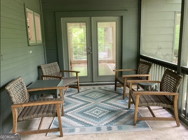 sunroom / solarium featuring french doors