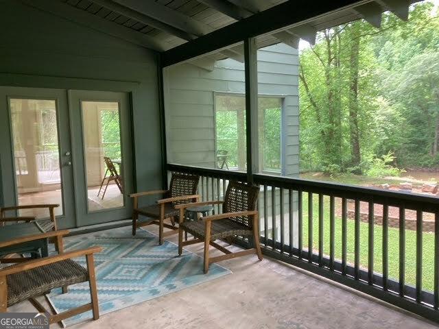 sunroom featuring a healthy amount of sunlight and vaulted ceiling with beams