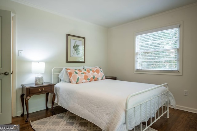 bedroom featuring ornamental molding and dark hardwood / wood-style floors