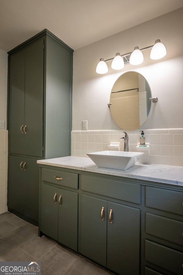 bathroom featuring vanity, tile patterned floors, and tile walls