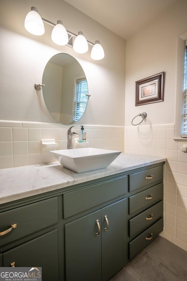 bathroom featuring tile patterned floors, vanity, and tile walls