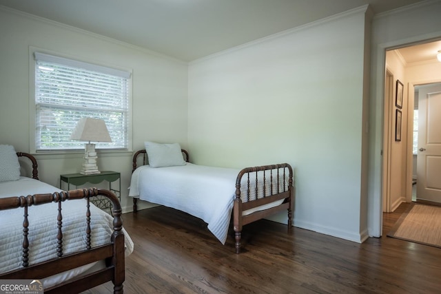 bedroom featuring crown molding and dark hardwood / wood-style flooring