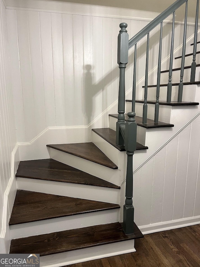 staircase with hardwood / wood-style flooring