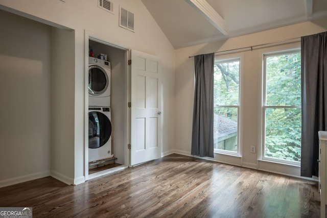 clothes washing area with stacked washing maching and dryer and dark hardwood / wood-style floors