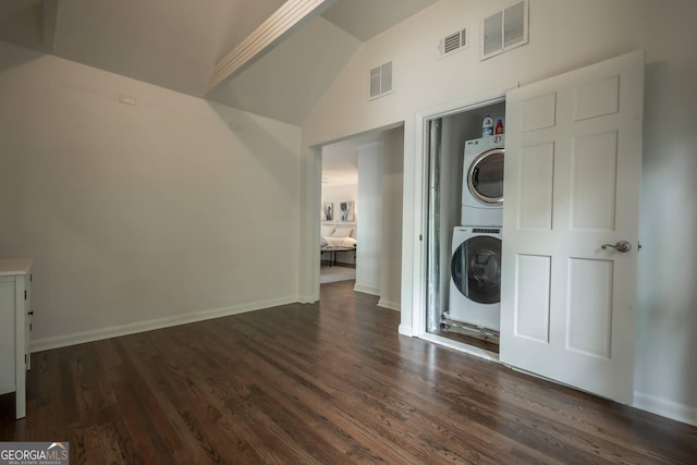 washroom with dark hardwood / wood-style floors and stacked washer and clothes dryer